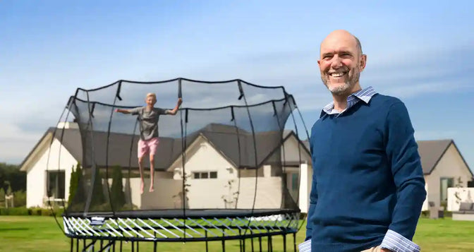 Dr.Keith beside a trampoline