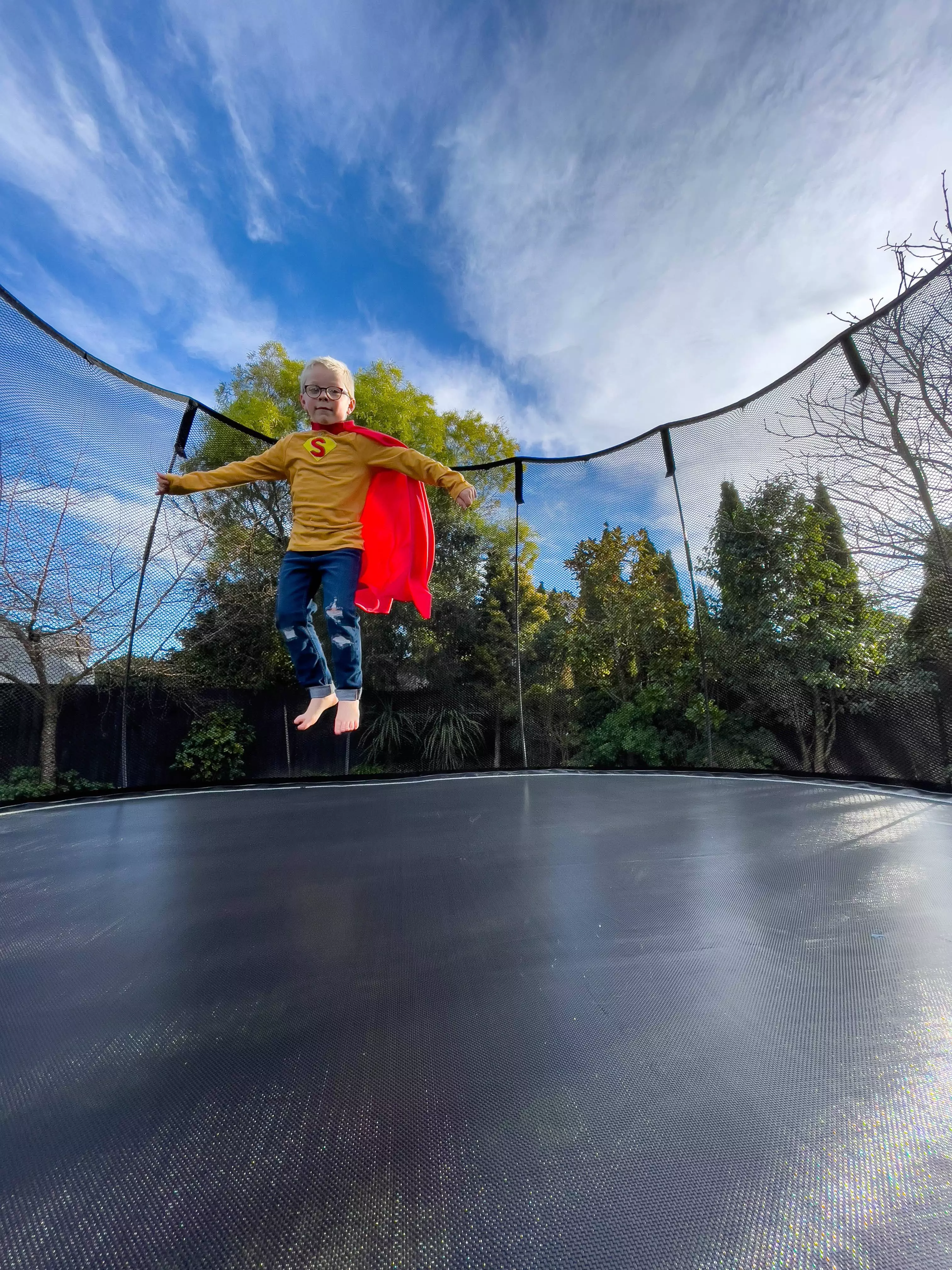 little boy bouncing on a square trampoline